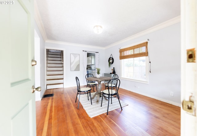 125 NE 80th Ave, Portland, OR 97213 - dining area with crown molding, stairway, and light wood-style flooring