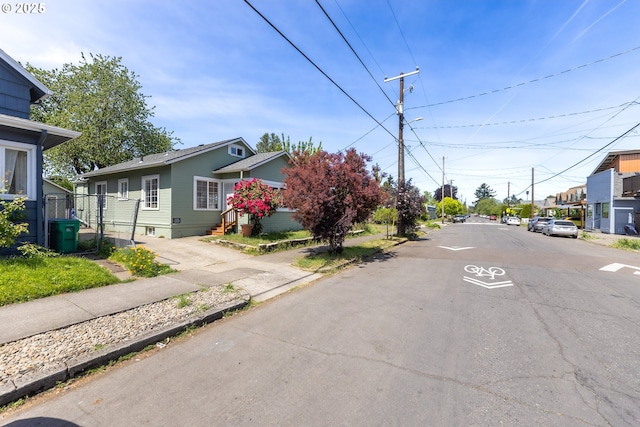 125 NE 80th Ave, Portland, OR 97213 - view of asphalt road with sidewalks, street lights, curbs, and a residential view