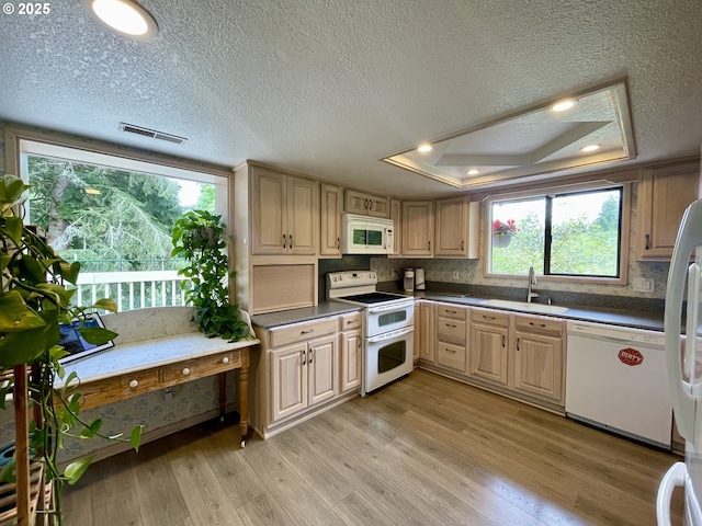 755 17th Ave, Coos Bay, OR 97420 - kitchen with white appliances, a sink, light wood-type flooring, dark countertops, and light brown cabinetry