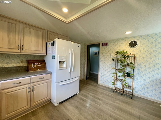 755 17th Ave, Coos Bay, OR 97420 - kitchen with white fridge with ice dispenser, baseboards, light wood-style flooring, wallpapered walls, and dark countertops