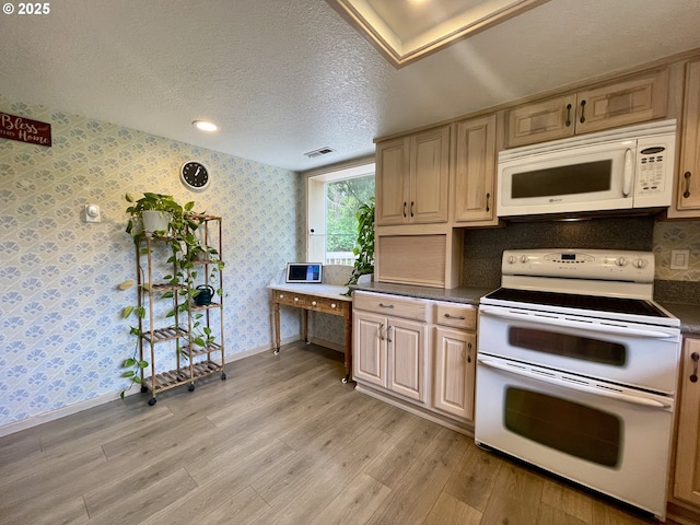 kitchen featuring white appliances, wallpapered walls, light wood-style flooring, dark countertops, and baseboards