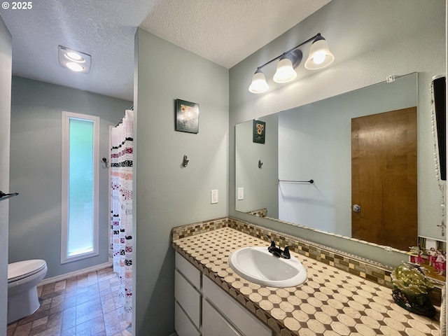 755 17th Ave, Coos Bay, OR 97420 - bathroom featuring vanity, toilet, a textured ceiling, curtained shower, and baseboards