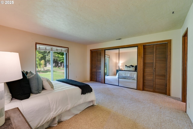 carpeted bedroom featuring a closet, visible vents, and a textured ceiling