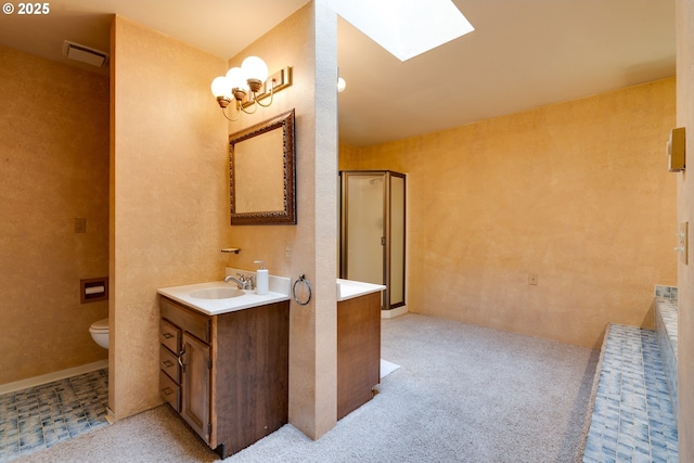 bathroom with a skylight, visible vents, toilet, a shower stall, and vanity