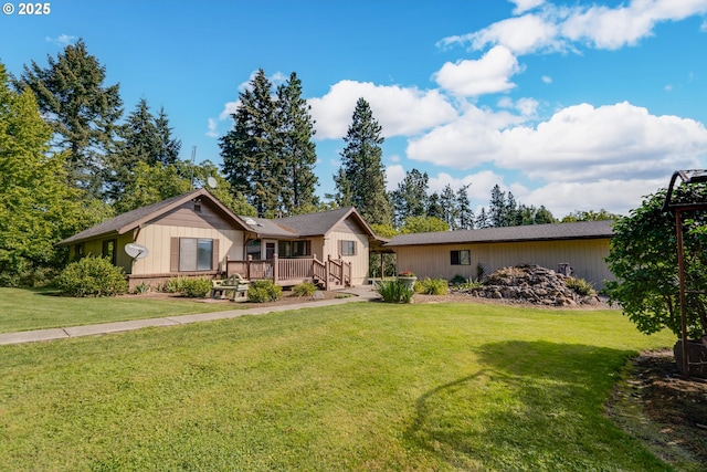 ranch-style home with a deck and a front yard