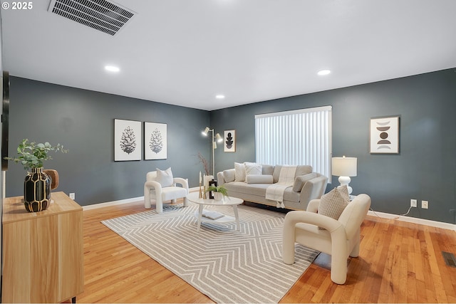living room with visible vents, recessed lighting, light wood finished floors, and baseboards