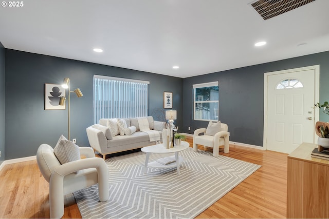 living area with recessed lighting, baseboards, visible vents, and light wood-style floors