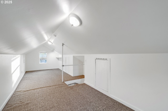 bonus room featuring carpet floors, baseboards, and lofted ceiling