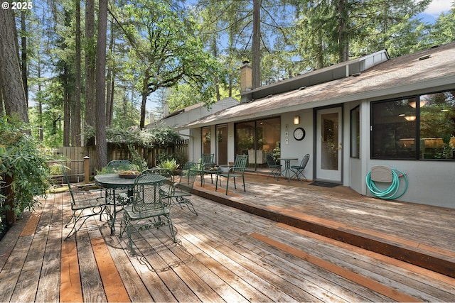 wooden deck with fence and outdoor dining space