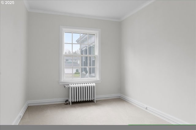 3707 SW 52nd Pl Unit 1, Portland, OR 97221 - spare room featuring radiator heating unit, carpet floors, crown molding, and baseboards