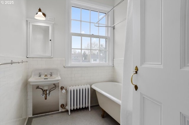 3707 SW 52nd Pl Unit 1, Portland, OR 97221 - full bath featuring radiator, a freestanding tub, wainscoting, and tile walls