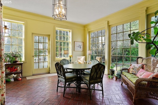 3707 SW 52nd Pl Unit 1, Portland, OR 97221 - sunroom featuring brick floors, healthy amount of natural light, a chandelier, and ornamental molding