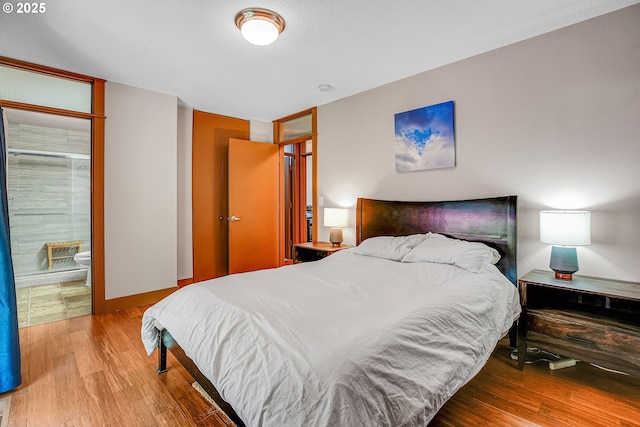 180 NW 107th Ave, Portland, OR 97229 - bedroom featuring wood finished floors and connected bathroom