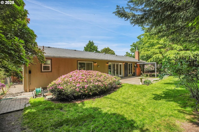 180 NW 107th Ave, Portland, OR 97229 - back of property featuring a chimney, a patio, and a yard