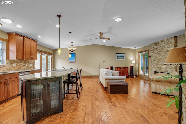 180 NW 107th Ave, Portland, OR 97229 - kitchen featuring open floor plan, dishwasher, ceiling fan, a kitchen breakfast bar, and lofted ceiling