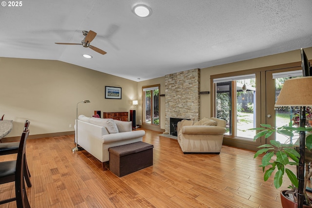 180 NW 107th Ave, Portland, OR 97229 - living area featuring plenty of natural light, vaulted ceiling, ceiling fan, light wood-type flooring, and a fireplace