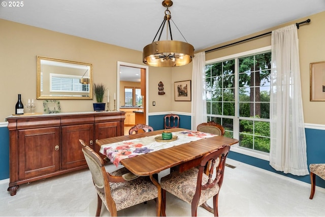 13910 SW Secretariet Ct, Beaverton, OR 97008 - dining room featuring light carpet, a chandelier, and baseboards