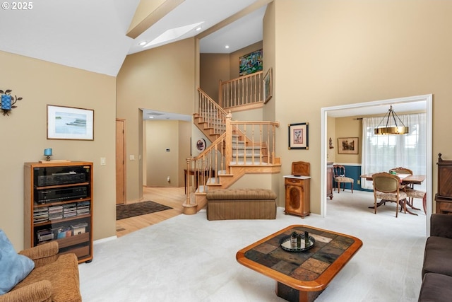 13910 SW Secretariet Ct, Beaverton, OR 97008 - living room with high vaulted ceiling, stairway, carpet floors, and baseboards