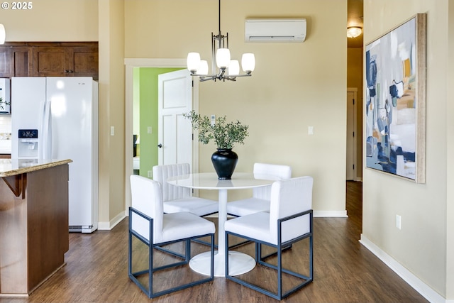 dining room featuring dark wood-type flooring, a wall mounted air conditioner, baseboards, and an inviting chandelier