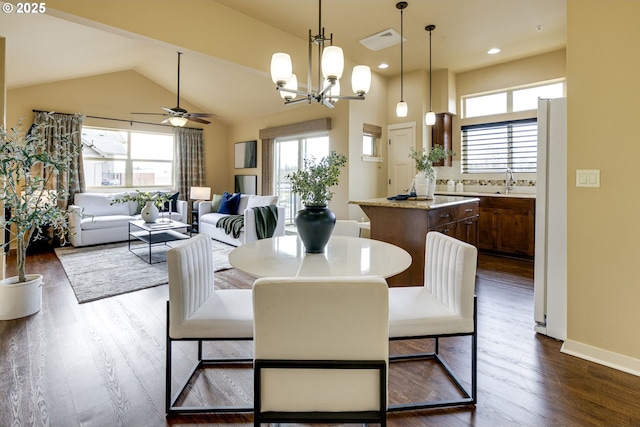 dining room featuring lofted ceiling, recessed lighting, dark wood-type flooring, visible vents, and baseboards