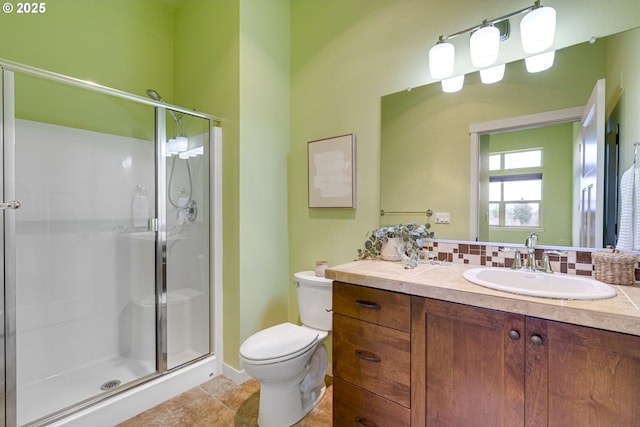 bathroom with a stall shower, backsplash, toilet, and vanity