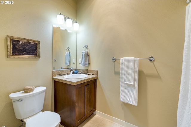 bathroom featuring toilet, vanity, baseboards, and tile patterned floors