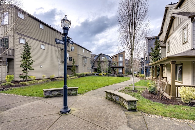 view of property's community with a lawn and a residential view