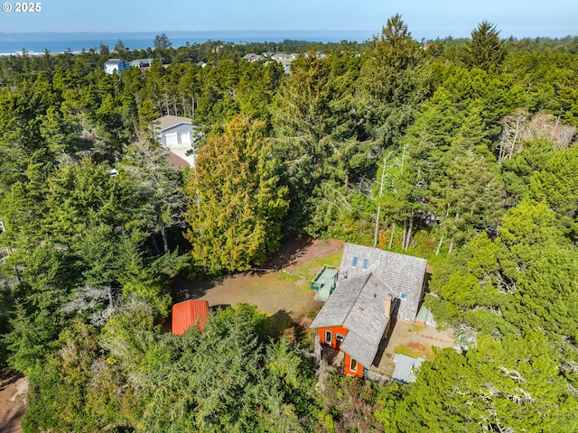 birds eye view of property with a forest view