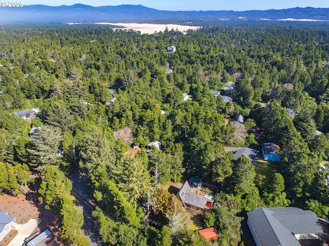 birds eye view of property featuring a mountain view and a view of trees