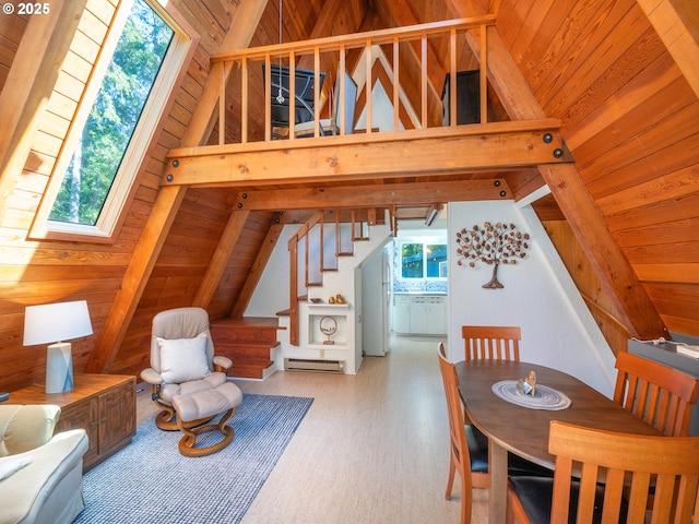 dining room with a skylight, wood ceiling, wooden walls, and stairs