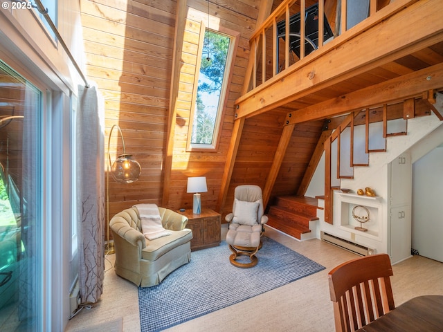 living area with wooden ceiling, a baseboard radiator, stairway, vaulted ceiling with beams, and wood walls