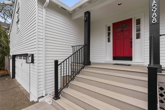 view of exterior entry with a garage