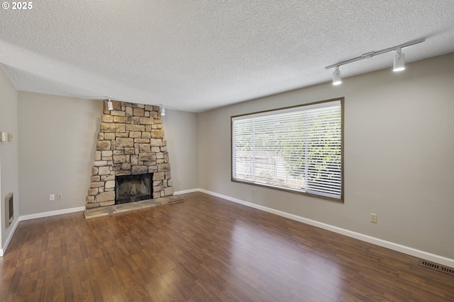 9115 NE Meadowbrook Cir, Vancouver, WA 98664 - unfurnished living room with a textured ceiling, rail lighting, wood finished floors, and a fireplace