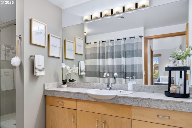 821 NW 11th Ave Unit 415, Portland, OR 97209 - ensuite bathroom featuring a shower stall, visible vents, ensuite bathroom, and vanity