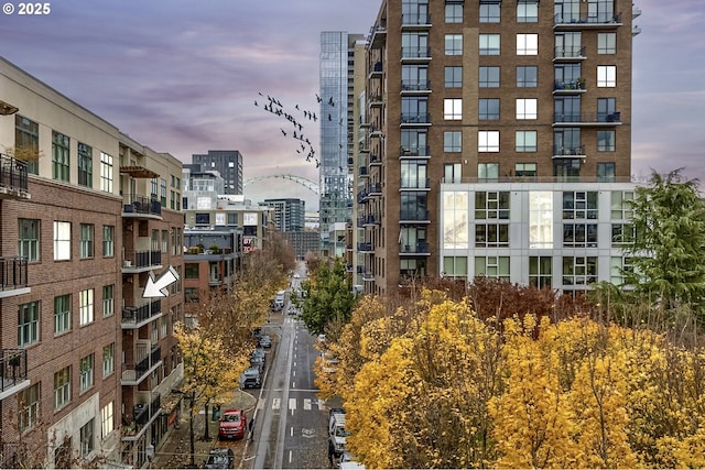 property at dusk with a city view