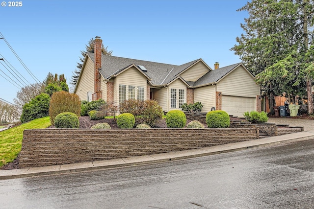 ranch-style home featuring an attached garage and fence