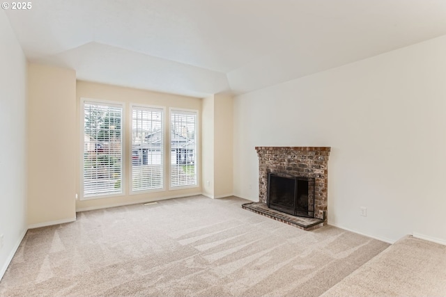 unfurnished living room with carpet, a fireplace, and baseboards