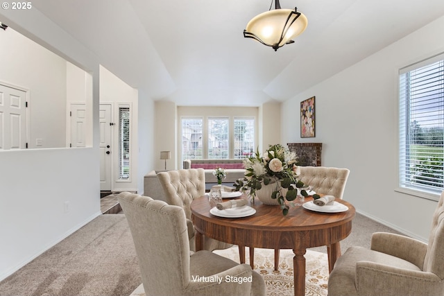 dining room with a wealth of natural light, carpet, and baseboards