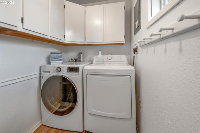 11144 NE Knott St, Portland, OR 97220 - laundry room with cabinet space, washer and clothes dryer, and light wood finished floors