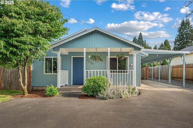 11144 NE Knott St, Portland, OR 97220 - view of front of house with driveway, an attached carport, and covered porch