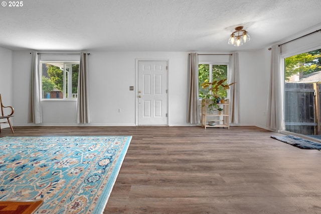 11144 NE Knott St, Portland, OR 97220 - foyer featuring a textured ceiling, wood finished floors, and a chandelier