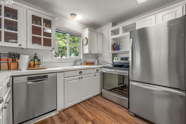 11144 NE Knott St, Portland, OR 97220 - kitchen with appliances with stainless steel finishes, open shelves, white cabinets, light countertops, and wood finished floors