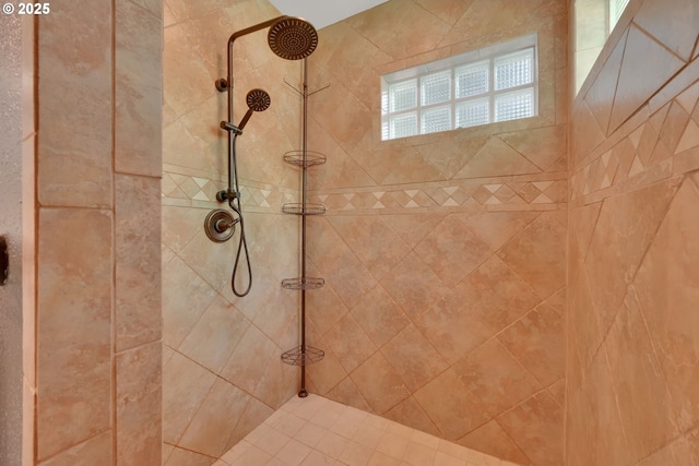 bathroom with tiled shower
