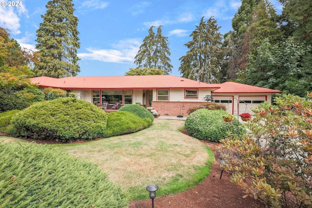 single story home with an attached garage, crawl space, a front lawn, and brick siding