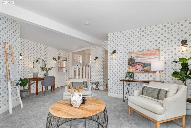 sitting room with beam ceiling and light carpet