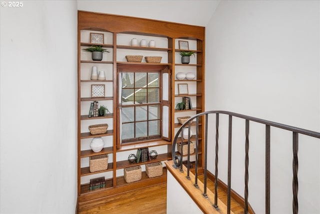 staircase with hardwood / wood-style flooring