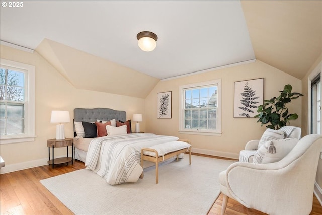 bedroom featuring wood-type flooring and vaulted ceiling