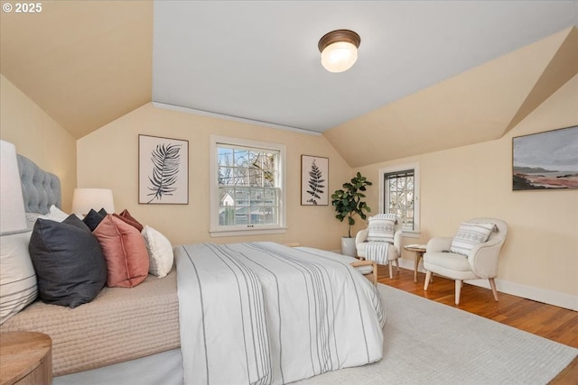 bedroom with hardwood / wood-style flooring and vaulted ceiling