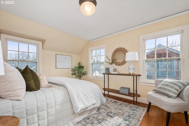 bedroom with vaulted ceiling and hardwood / wood-style floors