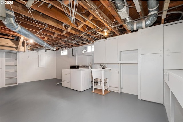 basement featuring sink and independent washer and dryer